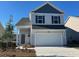 Two-story house with gray siding, a two-car garage, and a landscaped yard at 1075 Flintshire Dr., Myrtle Beach, SC 29579