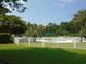 Community pool with white fence and lush landscaping at 562 Blue Stem Dr. # 54R, Pawleys Island, SC 29585