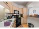 Corner kitchen with black appliances and light wood cabinets at 1301 Sweetwater Blvd. # 1301, Murrells Inlet, SC 29576