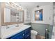Clean bathroom with blue vanity, updated fixtures, and a shower/tub combo at 517 S Ocean Blvd. # 705, North Myrtle Beach, SC 29582
