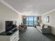 Living room features a sofa, TV, and dining area with ocean view at 1105 S Ocean Blvd. # 1204, Myrtle Beach, SC 29572