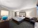 King bedroom with nightstands and a chair, plus a TV at 1105 S Ocean Blvd. # 1204, Myrtle Beach, SC 29572