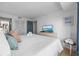 King-size bed, dresser, and TV in this bright bedroom at 5511 N Ocean Blvd. # 306, Myrtle Beach, SC 29577