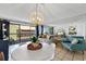 Bright dining area with white table and chairs, and a stylish light fixture at 5511 N Ocean Blvd. # 306, Myrtle Beach, SC 29577