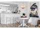 Small dining area with white table and chairs, kitchen view at 5511 N Ocean Blvd. # 306, Myrtle Beach, SC 29577