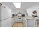 White kitchen with stainless steel appliances and tile backsplash at 5511 N Ocean Blvd. # 306, Myrtle Beach, SC 29577