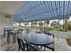 Outdoor patio dining area with striped awning at 5511 N Ocean Blvd. # 306, Myrtle Beach, SC 29577