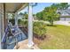 Front porch with chairs and view of a tree-lined street at 2009 Spring Valley Ct., Loris, SC 29569