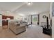 Open living room and kitchen with a large couch and plenty of natural light at 2009 Spring Valley Ct., Loris, SC 29569