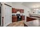 Well-equipped kitchen featuring dark wood cabinets and tile flooring at 2009 Spring Valley Ct., Loris, SC 29569