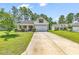 Single-Gathering home with driveway and landscaped yard at 2009 Spring Valley Ct., Loris, SC 29569