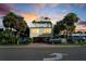 Two-story beach house with parking and palm trees at sunset at 4314 S Ocean Blvd. # B-1, North Myrtle Beach, SC 29582