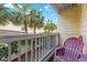 Private balcony with wooden railing and palm trees at 4314 S Ocean Blvd. # B-1, North Myrtle Beach, SC 29582