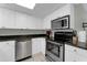 Modern kitchen with stainless steel appliances and white cabinets at 4314 S Ocean Blvd. # B-1, North Myrtle Beach, SC 29582