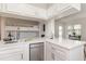 Modern white kitchen with stainless steel appliances and a breakfast bar at 4303 S Ocean Blvd. # 107, North Myrtle Beach, SC 29582