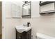 Clean bathroom with pedestal sink, vanity, and mirror at 4303 S Ocean Blvd. # 107, North Myrtle Beach, SC 29582