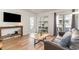 Living room with hardwood floors, a sofa, and access to a balcony at 4303 S Ocean Blvd. # 107, North Myrtle Beach, SC 29582