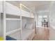 White bunk beds in a bedroom with access to the living area at 4303 S Ocean Blvd. # 107, North Myrtle Beach, SC 29582