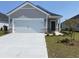 House exterior: one-story home with a white garage door at 782 Cypress Preserve Circle, Longs, SC 29568