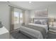 Bright bedroom with a large bed, neutral decor and window at 782 Cypress Preserve Circle, Longs, SC 29568