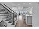 Elegant staircase with wrought iron railing, view to kitchen and living area at 312 West Palms Dr., Myrtle Beach, SC 29579