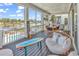 Screened porch with outdoor seating and water views at 312 West Palms Dr., Myrtle Beach, SC 29579