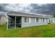 Rear view of the home with a screened porch and side yard at 213 Birkdale Ln., Myrtle Beach, SC 29588