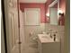 Bathroom with pink walls, white tile, and vanity at 880 Horry Rd., Aynor, SC 29511