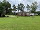 Side view of a brick house with a large grassy yard at 880 Horry Rd., Aynor, SC 29511