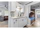 White kitchen with stainless steel appliances and a view of a bunk bed room at 6001 - N-45 S Kings Hwy., Myrtle Beach, SC 29575