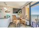Small dining area with table and chairs near the ocean at 6900 Ocean Blvd. N # 1205, Myrtle Beach, SC 29572