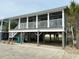 Elevated home with covered porch and parking underneath at 1521 N Waccamaw Dr., Murrells Inlet, SC 29576