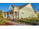 Side view of a light teal house, showcasing its architectural details at 8165 Living Tide Dr., Myrtle Beach, SC 29572