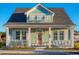 Charming light green house with a pink door and white shutters at 8165 Living Tide Dr., Myrtle Beach, SC 29572