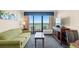 Condo living room with ocean view and seating for four at 1200 N Ocean Blvd. # 1002, Myrtle Beach, SC 29577