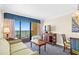 Condo living room with ocean view and seating for four at 1200 N Ocean Blvd. # 1002, Myrtle Beach, SC 29577