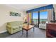 Condo living room with ocean view and seating at 1200 N Ocean Blvd. # 1002, Myrtle Beach, SC 29577