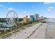 Aerial view showcasing the hotel's location near the beach and a Ferris wheel at 1200 N Ocean Blvd. # 1002, Myrtle Beach, SC 29577
