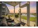 Cozy screened porch with string lights and lake view at 4503 W Harbour Circle # S1, Little River, SC 29566