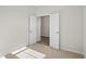 Well lit bedroom with neutral walls, carpeting, and double doors at 3050 Deerberry Place, Longs, SC 29568