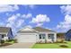 Light blue house with white garage door and landscaping at 3050 Deerberry Place, Longs, SC 29568