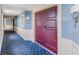 Elegant hallway with blue walls, patterned carpet, and a rich wood door at 100 North Beach Blvd. # 1512, North Myrtle Beach, SC 29582