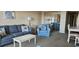 Living room with sofa, armchair, coffee table, and dining area at 7509 N Ocean Blvd., Myrtle Beach, SC 29572