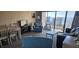 Living room with dining area, TV, comfortable seating and access to balcony overlooking the ocean at 7509 N Ocean Blvd., Myrtle Beach, SC 29572