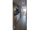 Kitchen with wood cabinets, tiled floor, and view into living area at 7509 N Ocean Blvd., Myrtle Beach, SC 29572
