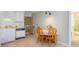 Kitchen with white cabinets, dishwasher, and a small dining area at 9620 Shore Dr. # 303, Myrtle Beach, SC 29572
