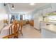 Bright kitchen features white cabinets, tile floor, and dining area at 9620 Shore Dr. # 303, Myrtle Beach, SC 29572