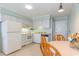 White kitchen cabinets, tile floor, and a dining table for two at 9620 Shore Dr. # 303, Myrtle Beach, SC 29572