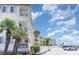 Exterior view of building with palm trees and parking at 9620 Shore Dr. # 303, Myrtle Beach, SC 29572