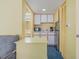 Small galley kitchen with white cabinets, microwave, and coffee maker at 2701 South Ocean Blvd. # 710, North Myrtle Beach, SC 29582